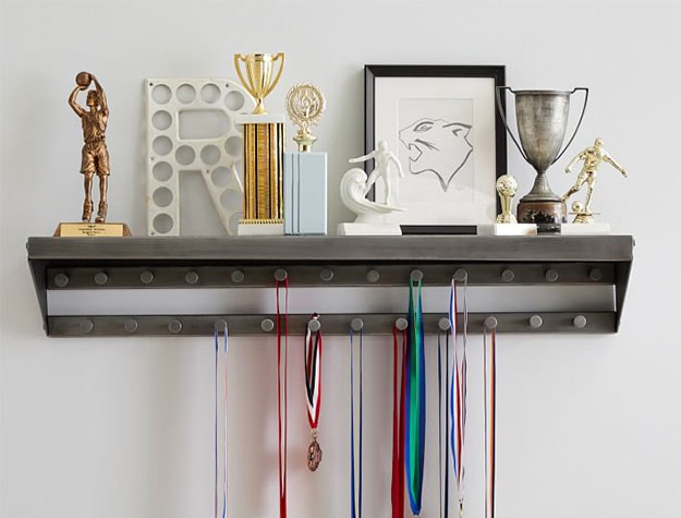 medals and awards displayed on bedroom shelf