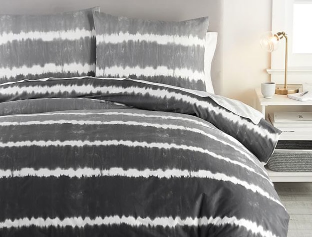 black and white tie-dye duvet on a bed