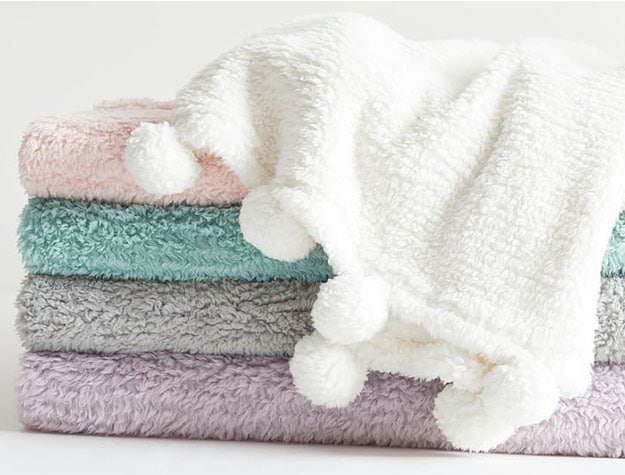 stack of soft throw blankets
