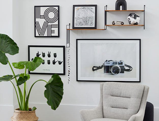gallery wall with black and white photos and art prints