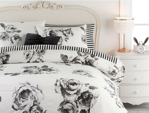 bed with black and white rose comforter
