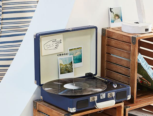 record player displayed on crate shelves