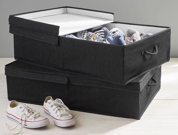 Black denim storage bins stacked and filled with shoes