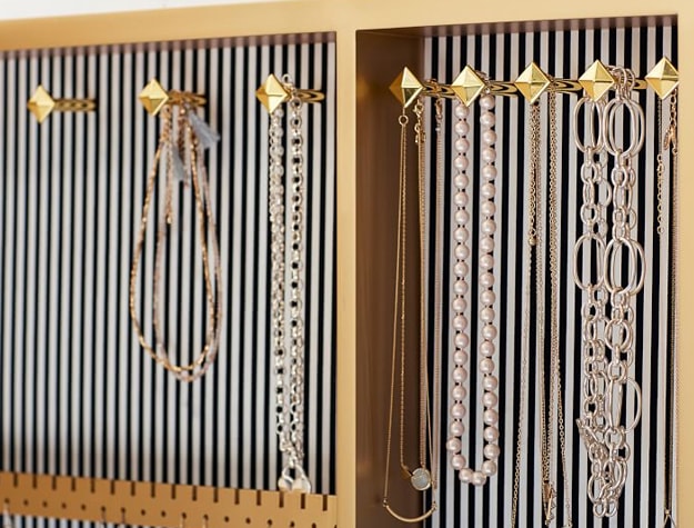 Jewelry hanging inside mirrored cabinet