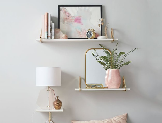 Shelves with photos, plant and mirror