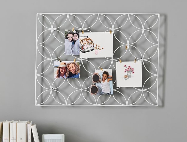 Floral wire photo display on gray wall