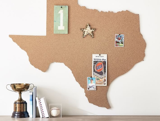 Texas state-shaped corkboard on wall above desk