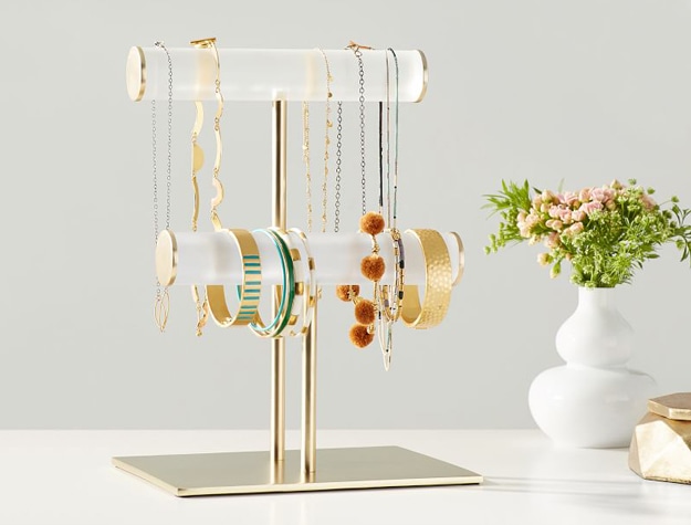 Acrylic and gold jewelry holder stand with bracelets and necklaces