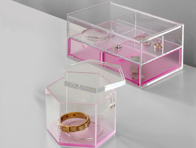Pink acrylic jewelry display cases on table