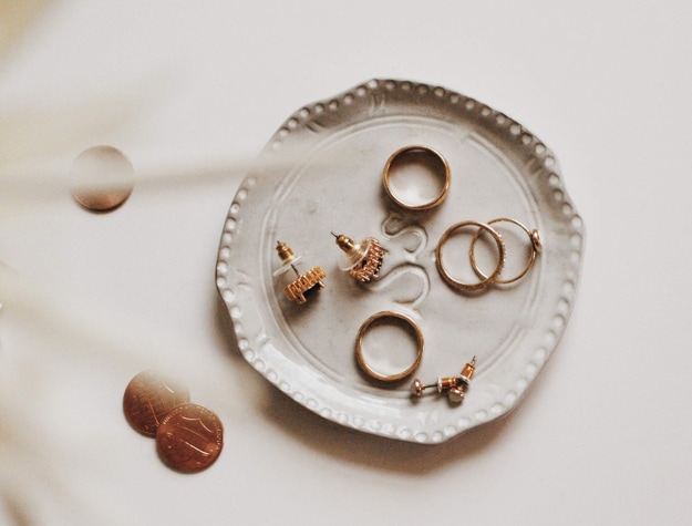 Small dish with rings and earrings on table