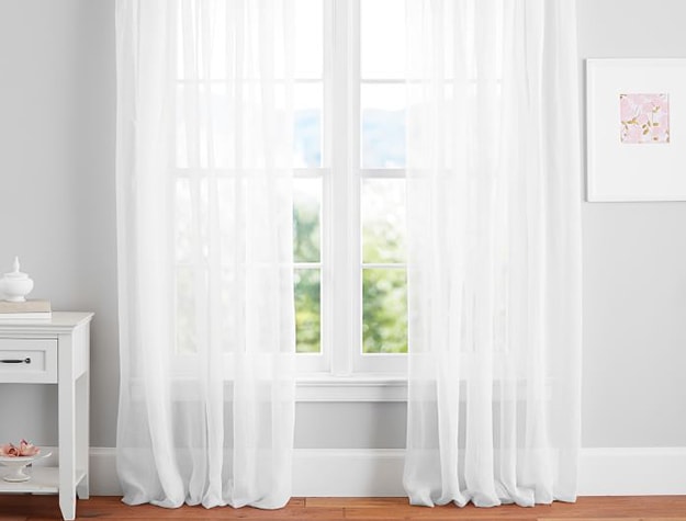 Linen sheer curtains in front of window.