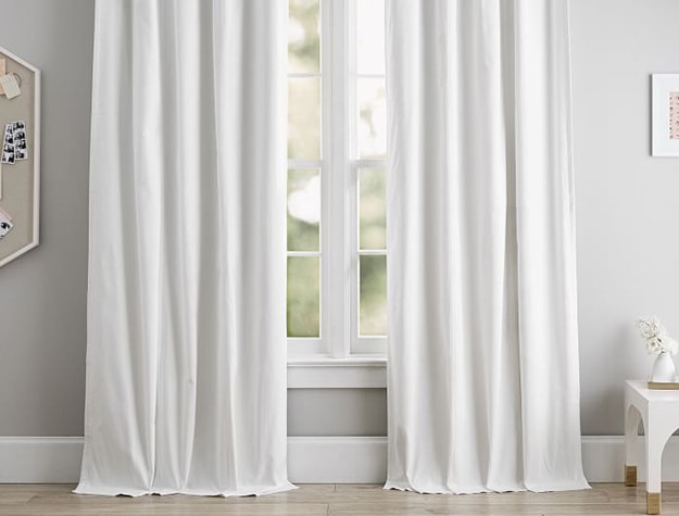 Classic grommet blackout curtains over window.