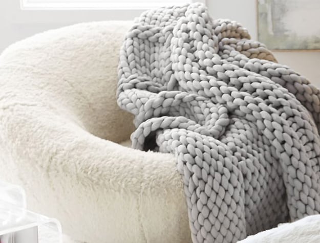 Super chunky knit throw on a chair.