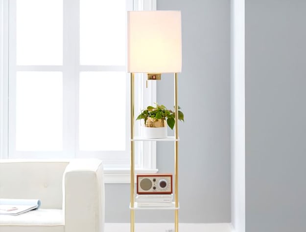 Harrison Shelf Floor Lamp with radio and potted plant next to a sofa.