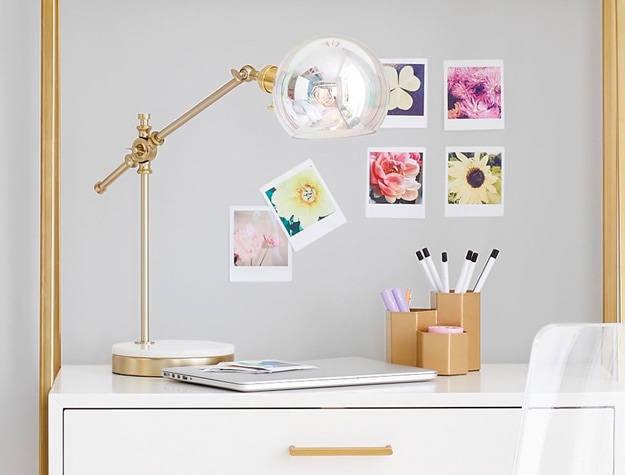 Marble Base Task Lamp on a desk with a laptop, office supplies and photos of flowers.