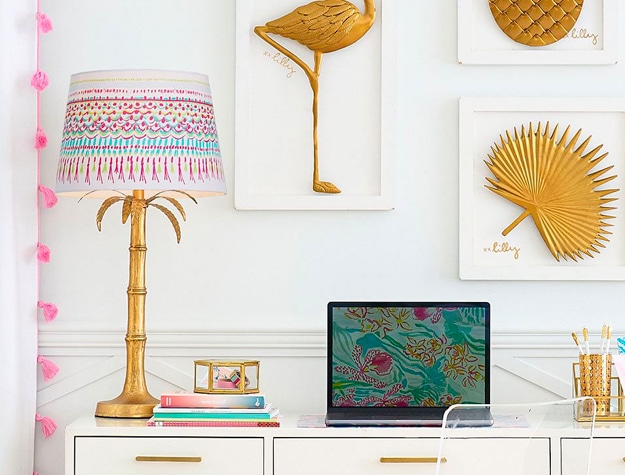 Lilly Pulitzer Polished Palm decorative table lamp on a desk with a laptop and office supplies.