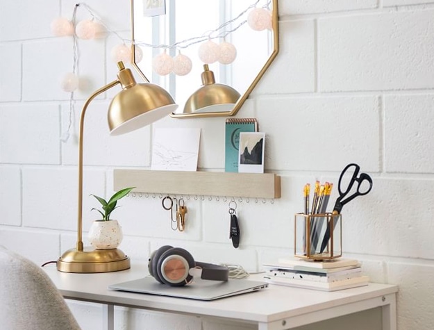 Kennedy Task Lamp with USB on top of a well-organized desk with laptop and headphones. There is an octagonal mirror on the wall.