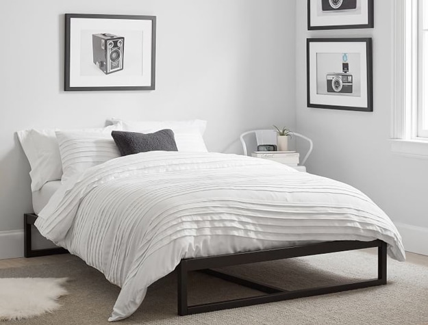 Parker platform bed in black styled with an off-white comforter and neutral rug.