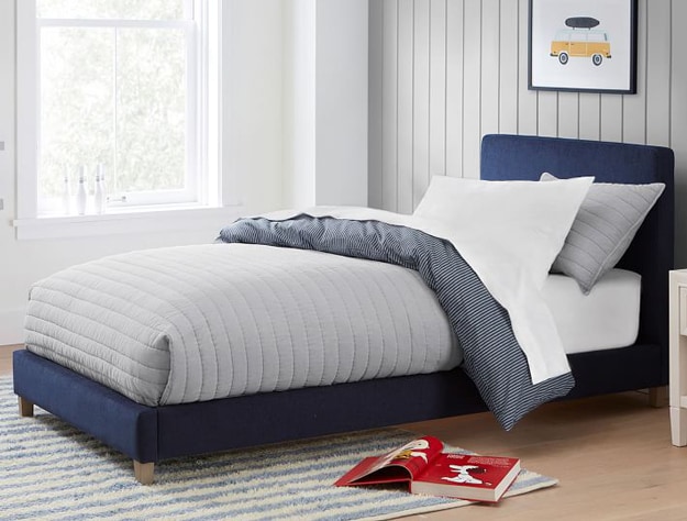 Payton upholstered twin bed in dusty indigo velvet styled with light gray bedding.