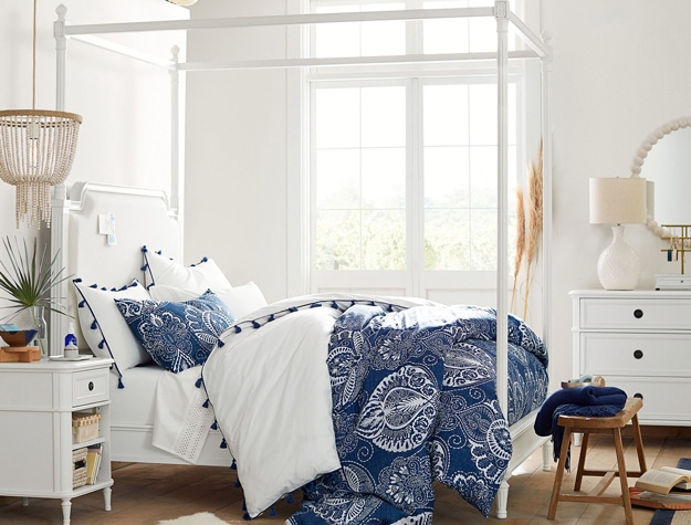 Colette canopy bed styled with a navy comforter.
