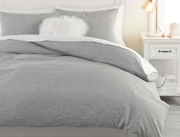 A gray Belgian Linen Duvet Cover styled with crisp white sheets and a classic white wooden bed frame.