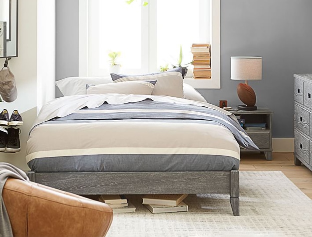 Beachstone Stripe Duvet Cover in gray multi-stripe styled on a gray platform bed frame with a matching nightstand.