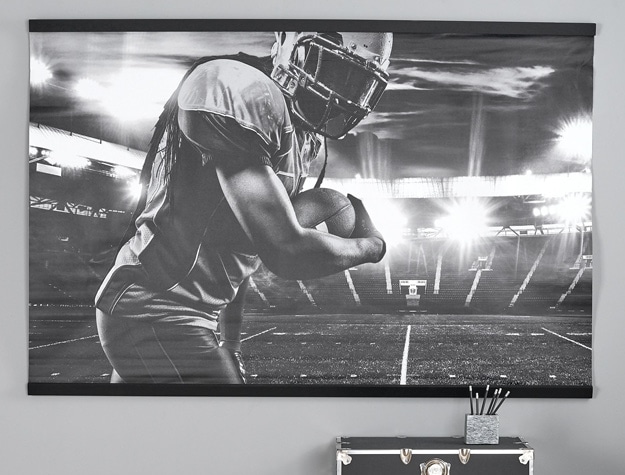 A black and white photo of a football player displayed above a black chest.