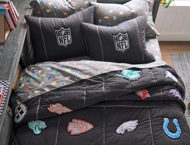 NFL themed bedding on a twin bed in a bedroom
