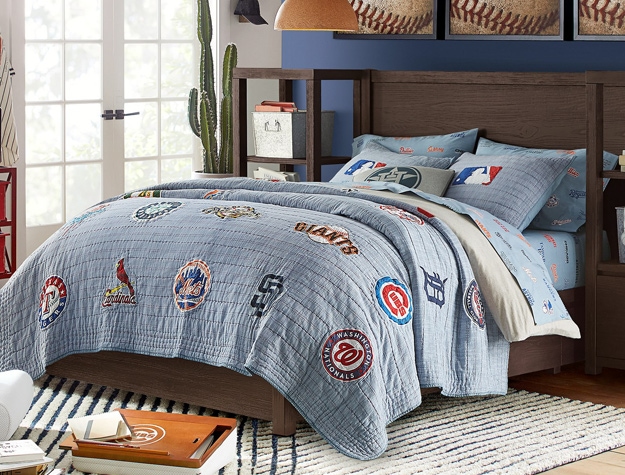 A baseball themed room with MLB bedding, baseball wall art and an MLB lapdesk.