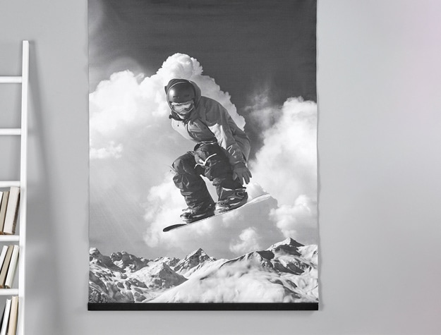 a black and white image of a snowboarder displayed next to a white bookshelf