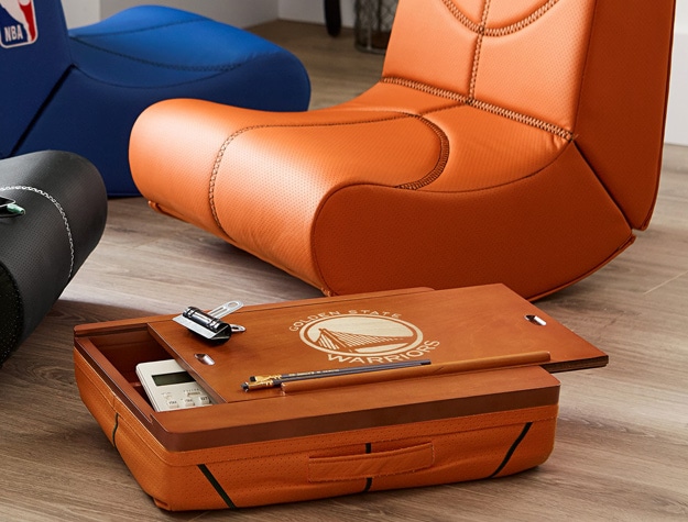 a Golden State Warriors lapdesk containing a calculator sitting next to a basketball rocking chair