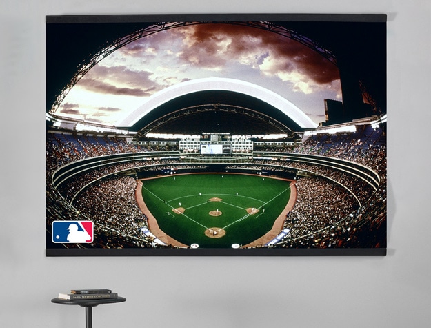 a mural showing an MLB stadium hanging next to a black stool