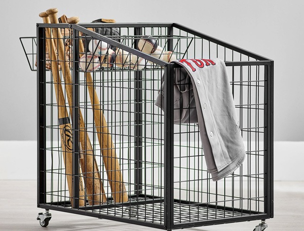 a metal gear cart holding multiple bats, baseballs and a baseball jersey