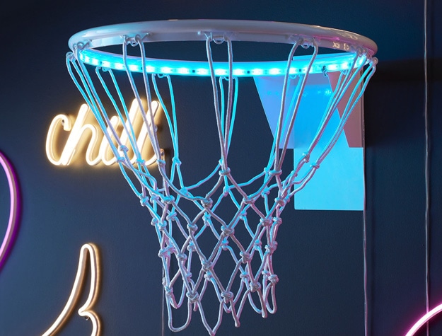 a glow-in-the-dark basketball hoop displayed amongst other neon signs