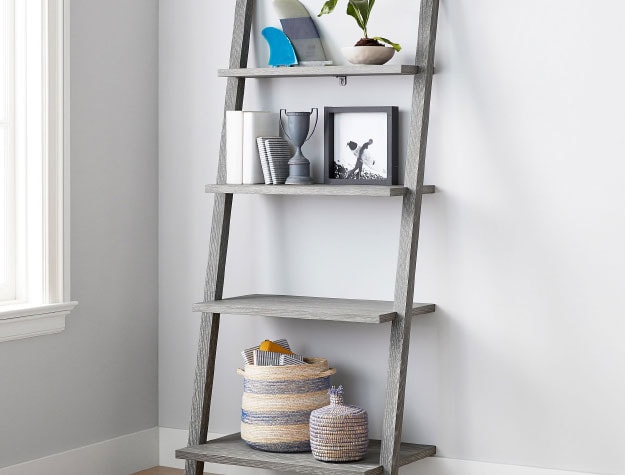A ladder bookshelf leaning against a wall.