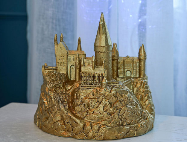 A Hogwarts night sky projector sitting on top of a desk.