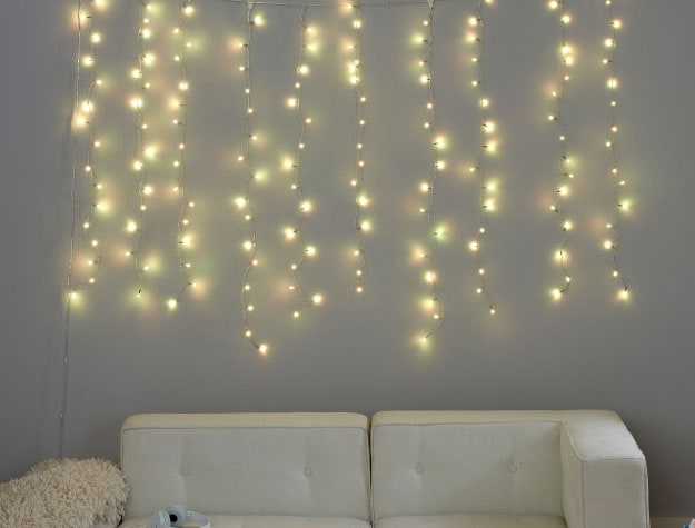 A set of waterfall string lights above a couch.