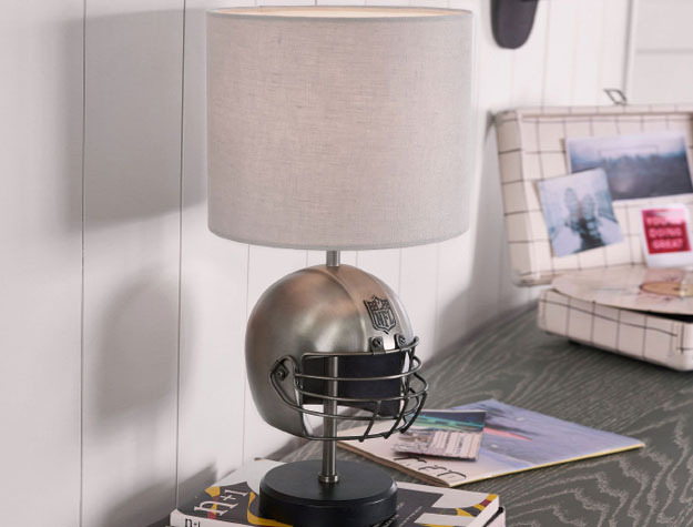 A football helmet lamp sitting on a desk.