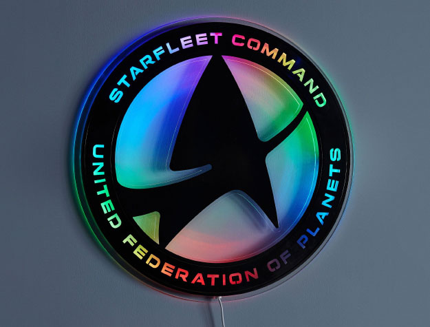 A Star Trek™ LED light hanging on a wall.