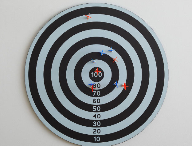 A magnetic dart board hanging on a wall.