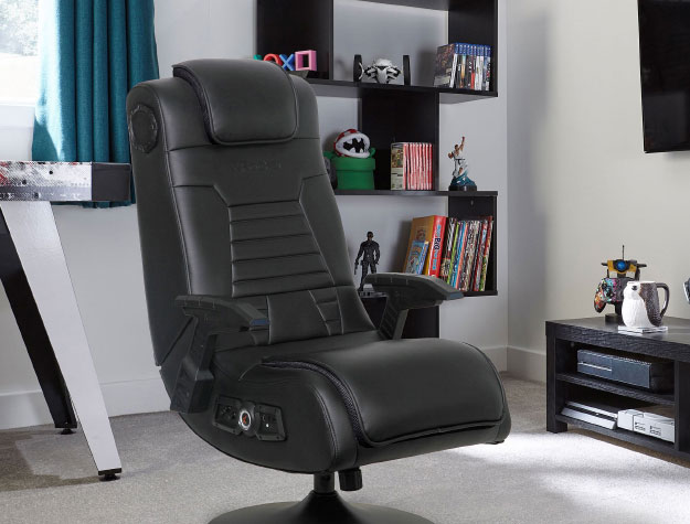 A leather gaming chair in the middle of a bedroom.