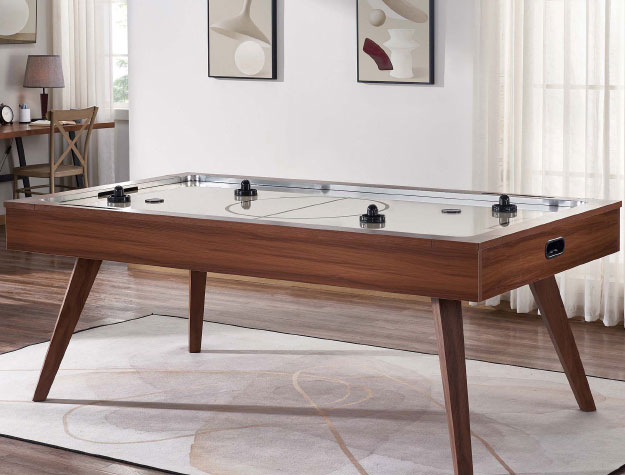 A wooden air hockey table in a living room.