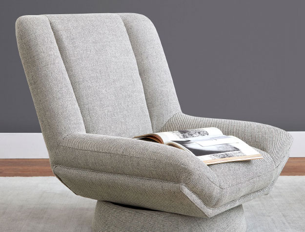 A grey swivel chair in a living room.