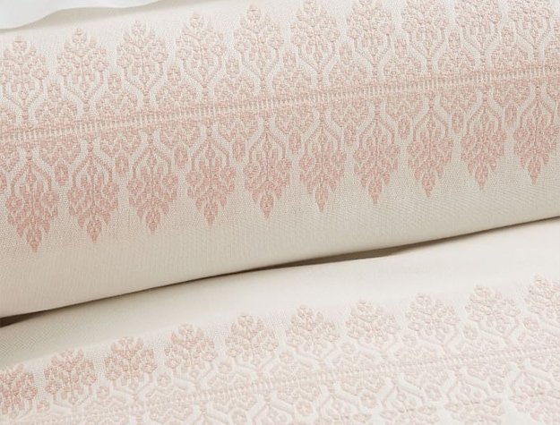 Ivory jacquard duvet cover with pink ornate detailing.