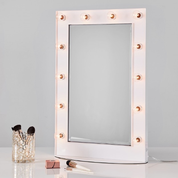 White and clear vanity mirror with bulb lights.