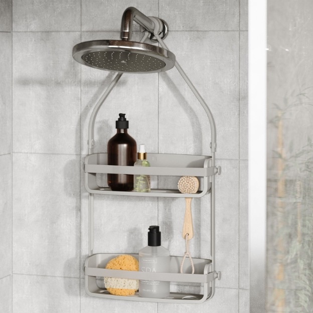 Metal shower caddy hanging over shower head holding bathing products.