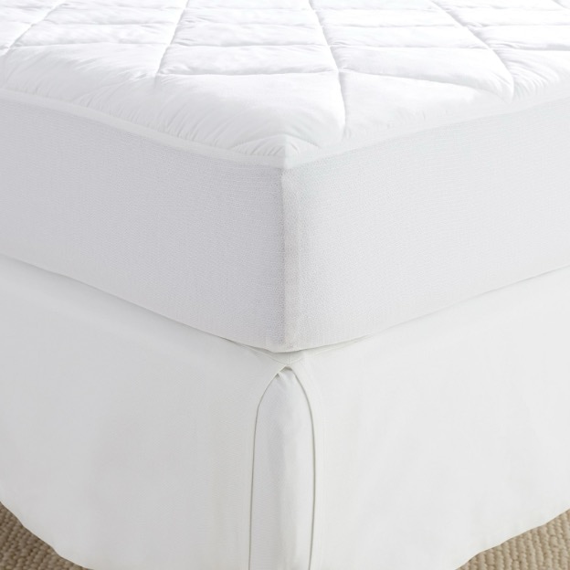 A white mattress protector and pad shown on a twin XL dorm bed.