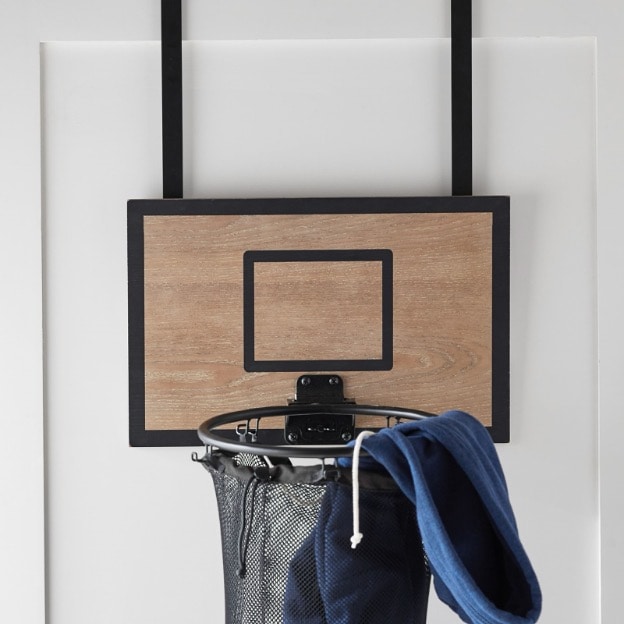 The basketball hoop hamper conveniently hangs over the door 