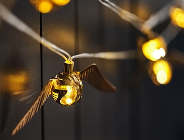 String lights inspired by the Golden Snitch from Harry Potter hang in a room.