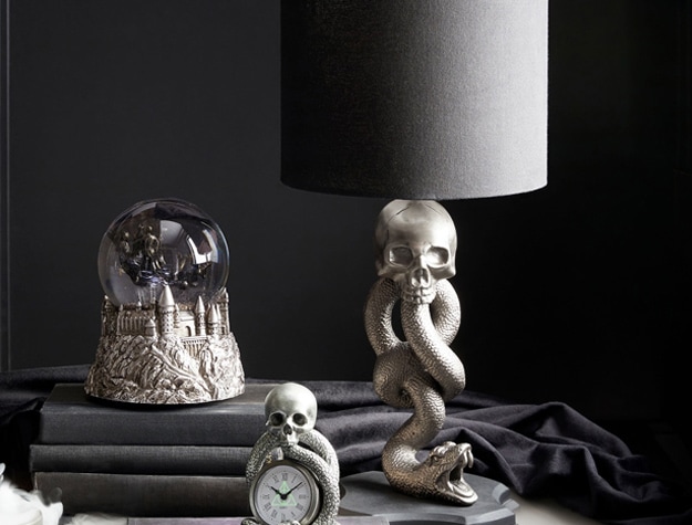 This pewter-finished lamp features a black linen shade and a stand shaped like the Dark Mark worn by every Death Eater.